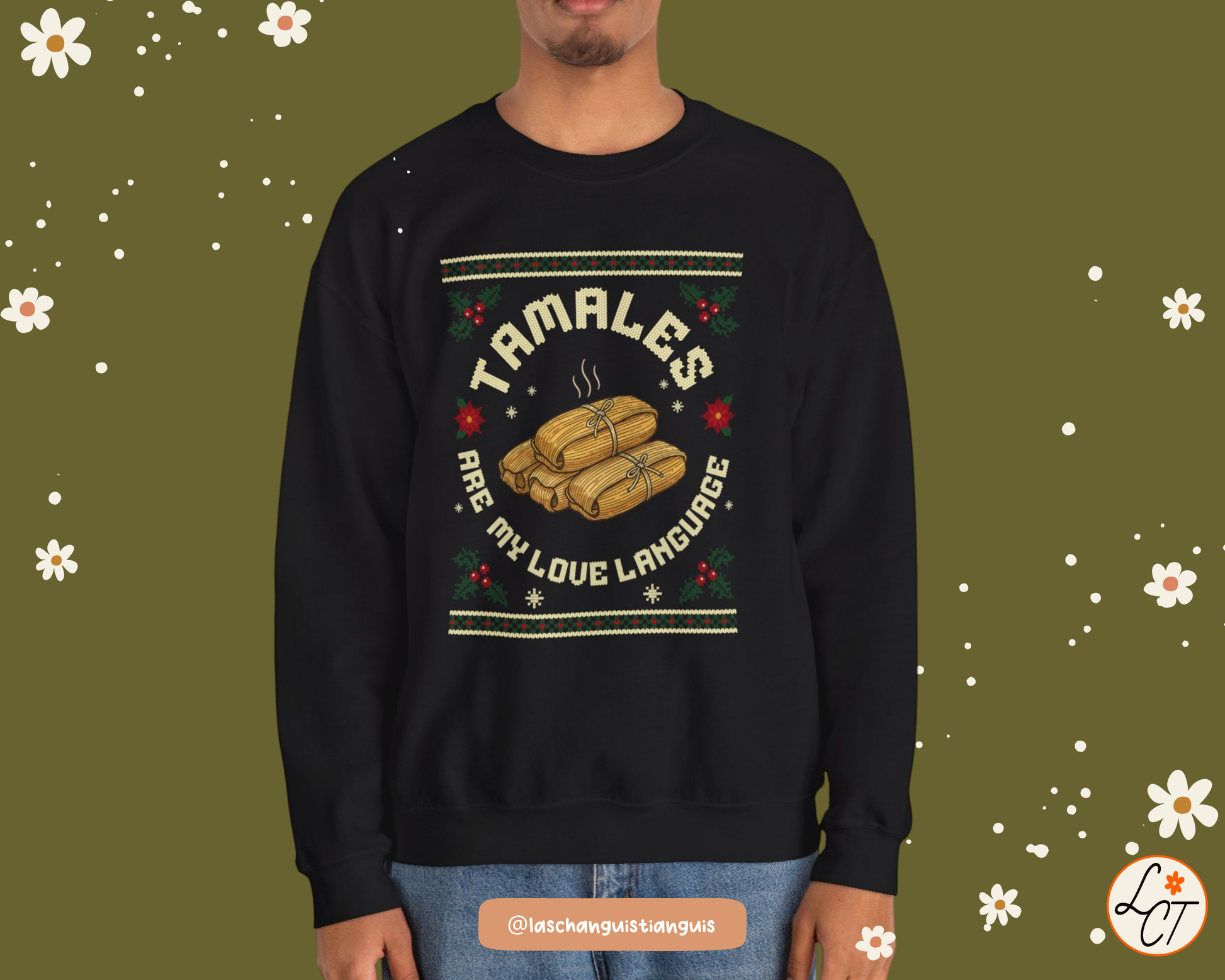 Holiday crewneck with tamales and poinsettias, styled flat lay with sneakers and sunglasses.